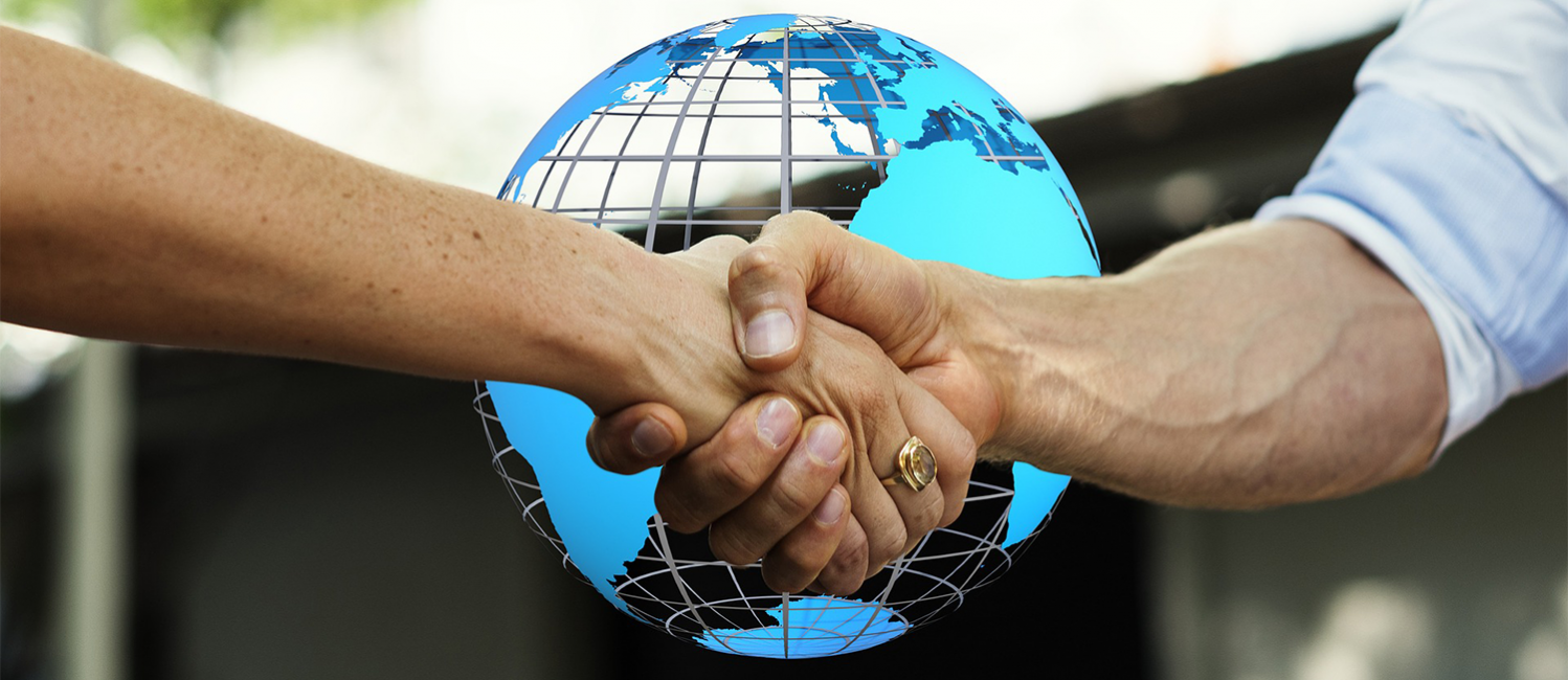 shaking hands over globe